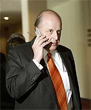 US Ambassador to the United Nations John D. Negroponte speaks on a mobile phone 