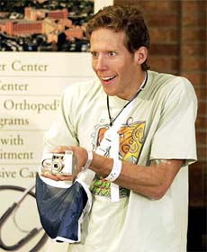 27-year-old climber Aron Ralston takes pictures of the media 