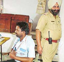 Surinder Jindal (left) at the Phase VIII police station in SAS Nagar on Saturday.