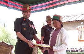 Brig R. Kapoor, SC, Commandant, 14 Gorkha Training Centre, Subhathu, presents badges of honour to a family member of a martyr
