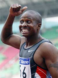 Men's 100 metres world record holder sprinter Tim Montgomery of the USA celebrates upon winning the men's 100 metres final