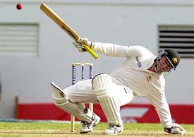 Stuart MacGill of Australia falls to the ground