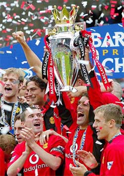 Manchester United's Ruud Van Nistelrooy holds the English Premier League trophy after the 2-1 win over Everton in their match at Everton's Goodison Park ground 