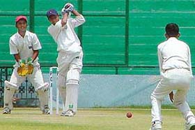 Simranjit Singh of SAS Nagar in action while Rajiv Rishi tries to stop the ball