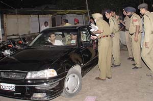 Police officials conduct an enquiry into the incident in which six persons broke into a booth in Sector 22. 