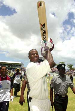 West Indies all-rounder Omari Banks waves his bat after West Indies beat  Australia by three wickets