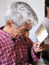 One of the survivors of the Nandimarg carnage holds a relief cheque at a function in Jammu