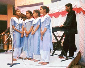 Students of Government Elementary School, Kailash Nagar,present a group song on the occasion of the annual prize distribution function