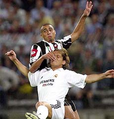Juventus' David Trezeguet and Real Madrid's Michel Salgado jump for the ball