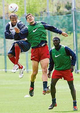 Arsenal�s Thierry Henry fights for the ball with team-mates Stathis Tavlaridis and Kolo Toure 