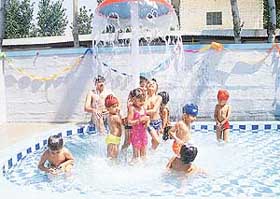 Children of Golden Bells Public School take a splash in the school pool to beat the heat.