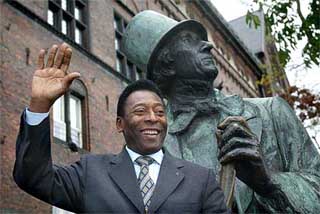 Brazilian soccer legend Pele poses in front of a statue of Danish author Hans Christian Andersen in Copenhagen
