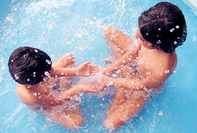 Children enjoy the cool environs at a swimming pool in the Capital on Saturday.