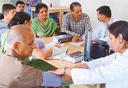 Patients being examined at a free homoeopathic dispensary
