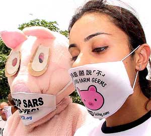 Activists of the People for the Ethical Treatment of Animals distribute masks