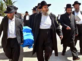Ultra orthodox Jews carry the body of Olga Brenner, 52, during her funeral in Jerusalem