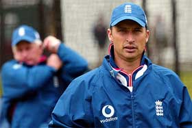 England captain Nasser Hussain and coach Duncan Fletcher look on during a team training session