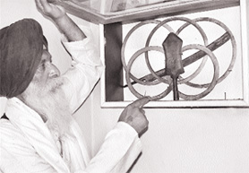 Chief sevadar Prem Singh shows some of the weapons recovered from a well.  The khanda shows 1694 as the year of its manufacture