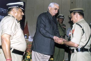 Union Finance Minister Jaswant Singh gives away the police medal for gallantry to a BSF personnel