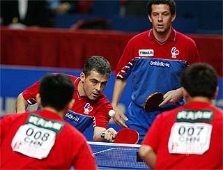 Jean Philippe Gatien and Patrick Chila of France keep their eyes on ball