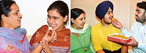 Anu Bhasin of Govt Model Senior Secondary School, Sector 37, Chandigarh, being offered a sweet by her mother. (R) Topper Barinder Singh of Bhavan Vidyalaya, Sector 27, Chandigarh, shares happy moments with his family. 