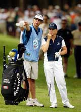 Sweden's Annika Sorenstam gets some advice from caddie Terry McNamara after missing the 5th fairway