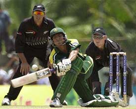 Pakistani batsman Younis Khan bats as New Zealand wicketkeeper Brendon McCullum and captain Stephen Fleming look on