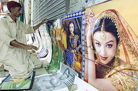 A Pakistani vendor displays posters of Indian movie stars at a roadside shop in Multan