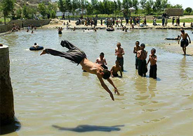 A child jumps into Kabul river to get some relief from the scorching heat