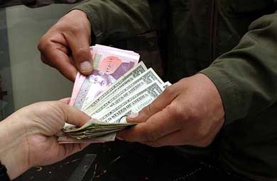 An Iraqi electricity company employee receives his salary in Baghdad