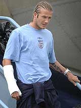 England soccer captain David Beckham, wearing a plaster cast, arrives at Luton airport
