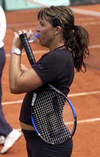 US tennis star and 2001 champion Jennifer Capriati drinks water during a training session