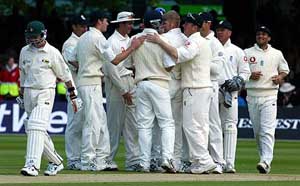 England's Anthony McGrath gets a pat on the back after he took the catch of Zimbabwe opener Dion Ebrahim 