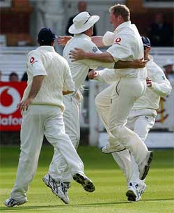 England's Anthony McGrath leaps into the arms of Michael Vaughan