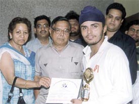 Reetender Singh Sodhi receiving the man of the match award in the opening match of the Lala Hari Ram Day-Night Cricket Tournament