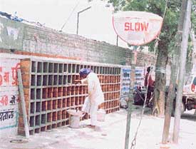 Construction of a shoe stand along the boundary wall of the Government College for Women under way