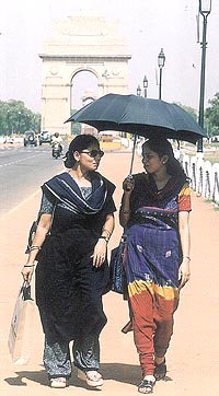 As the mercury rises, these ladies take the help of a brolly at Rajpath in the Capital on Tuesday.