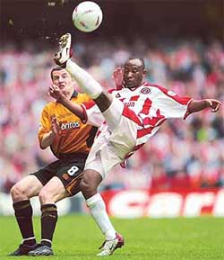 Sheffield United's Peter Ndlovu clears the ball from Wolverhampton Wanderers' Dennis Irwin  during their division one play-off final 