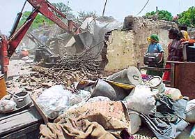 A JCB razes illegal structures to the ground in Phase I, SAS Nagar