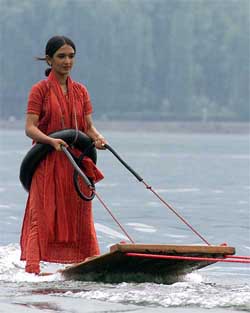 A tourist enjoys water surfing on Dal Lake in Srinagar