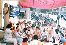 Members of the Sanchar Nigam Executive Association sit in dharna at the General Manager Telecom office