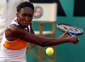 Venus Williams of the US makes a backhand return during her match against compatriot Samantha Reeves