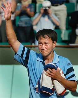Michael Chang of the US cries as he leaves the centre court for the last time after he lost to Frabrice Santoro of France