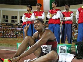 Sri Lankan athlete Susanthika Jayasinghe flashes a victory sign after winning the Women's 100-meter race