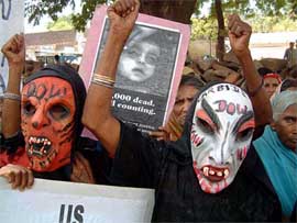 Bhopal gas victims and their family members demonstrate outside a Bhopal court
