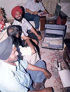 Vigilance sleuths count the money recovered in the residence of the Chief Electrical Inspector of the PSEB