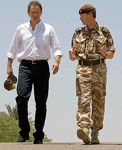 Britain's Prime Minister Tony Blair talks with Brigadier Adrian Bradshaw CBE