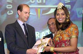 Former Miss World 1997 Diana Hayden presents the Earl of Wessex with the Indian bid