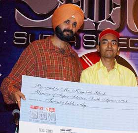 Former Indian cricketer Navjot Singh Sidhu presents a cheque