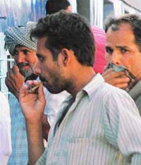 Going up in smoke!: A man puffs at the railway station unmindful of the ban on smoking at public places